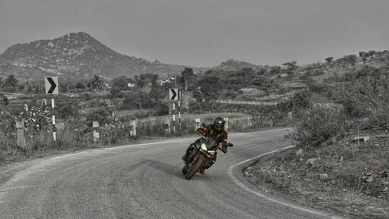 A rider on a winding hill road